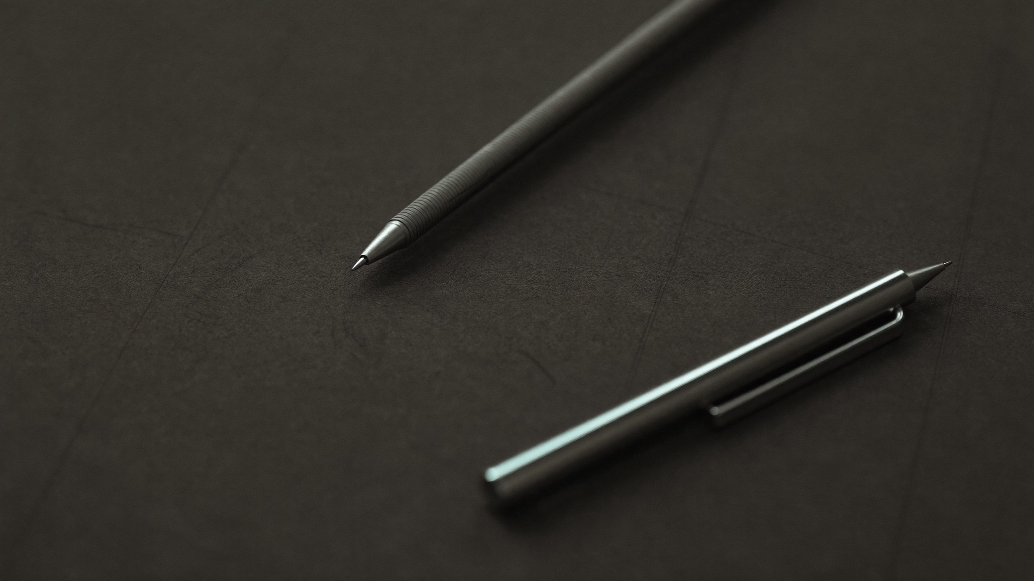 Blank dark grid paper with a mechanical pencil
