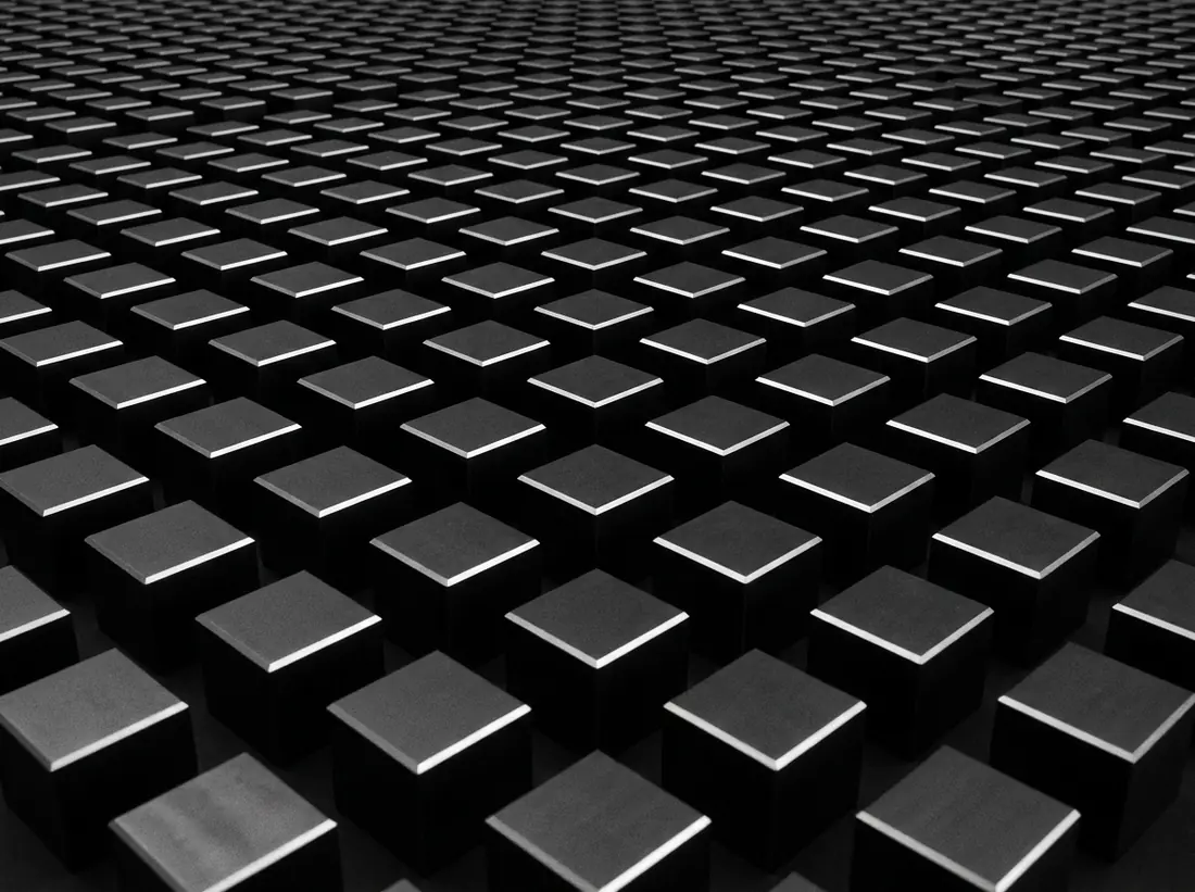 A vast grid of identical matte black cubes receding into darkness
